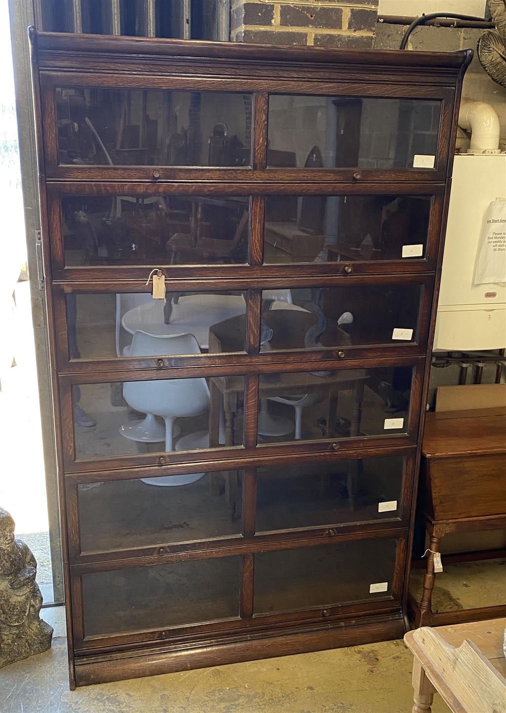 An early 20th century Gunn oak six section bookcase, length 126cm, depth 29cm, height 208cm